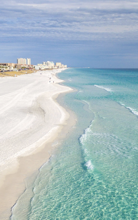 Aerial view of white sand beach and turquoise Gulf water