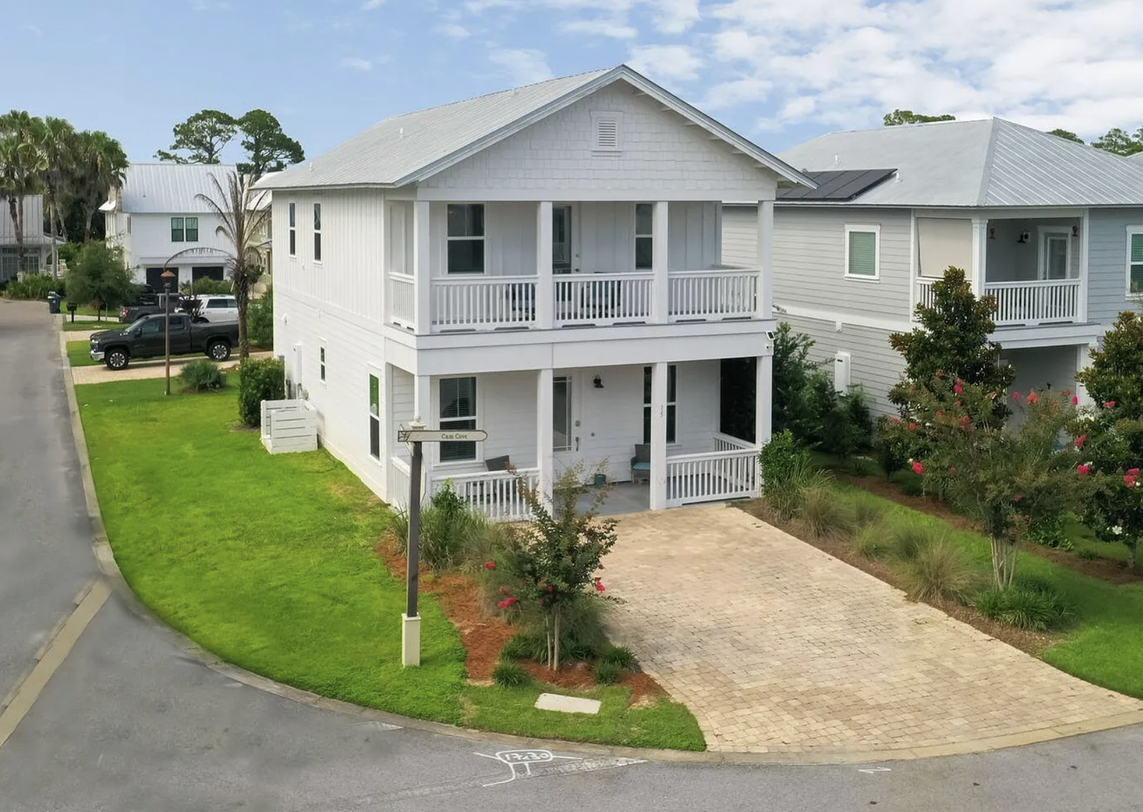 Aerial view of 15 Cam Cove on corner lot with brick paver driveway
